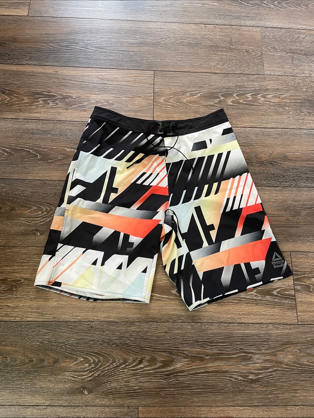 Reebok Men’s Black Athletic Shorts with Red and Orange Gradient Geometric Print